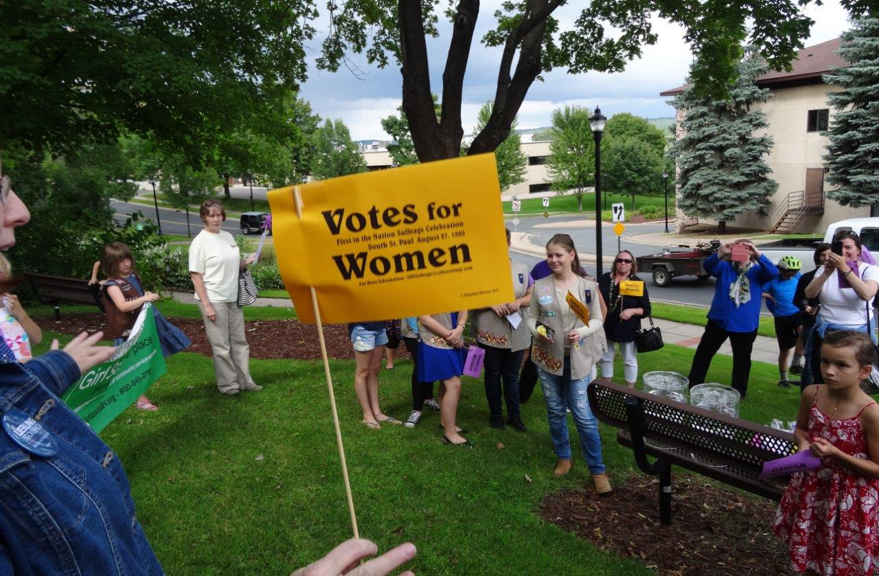 A participant waves a "Votes for Women" flag during "The World's Shortest Suffrage Parade" in 2017.