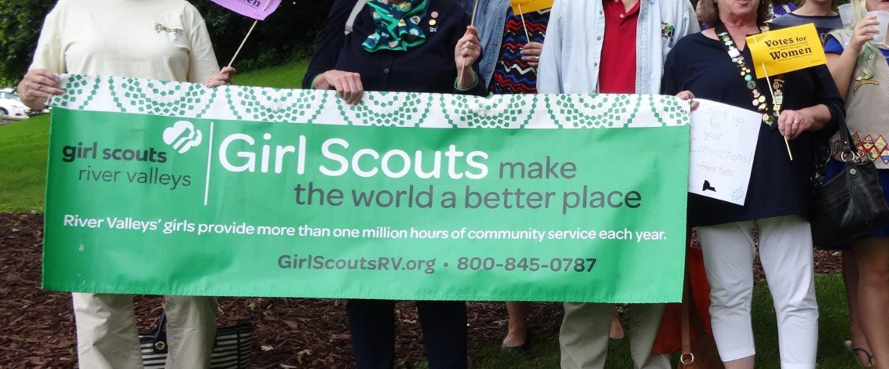 Girl Scouts proudly display their banner during the "World's Shortest Suffrage Parade."